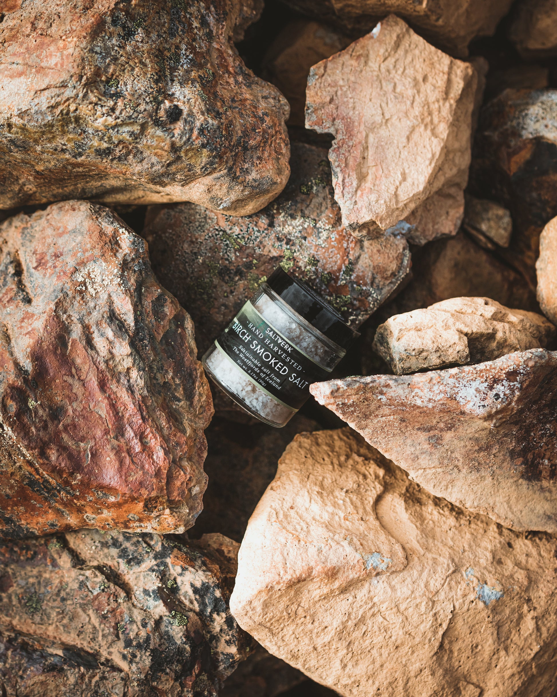 Jar of cream lying on a pile of rocks